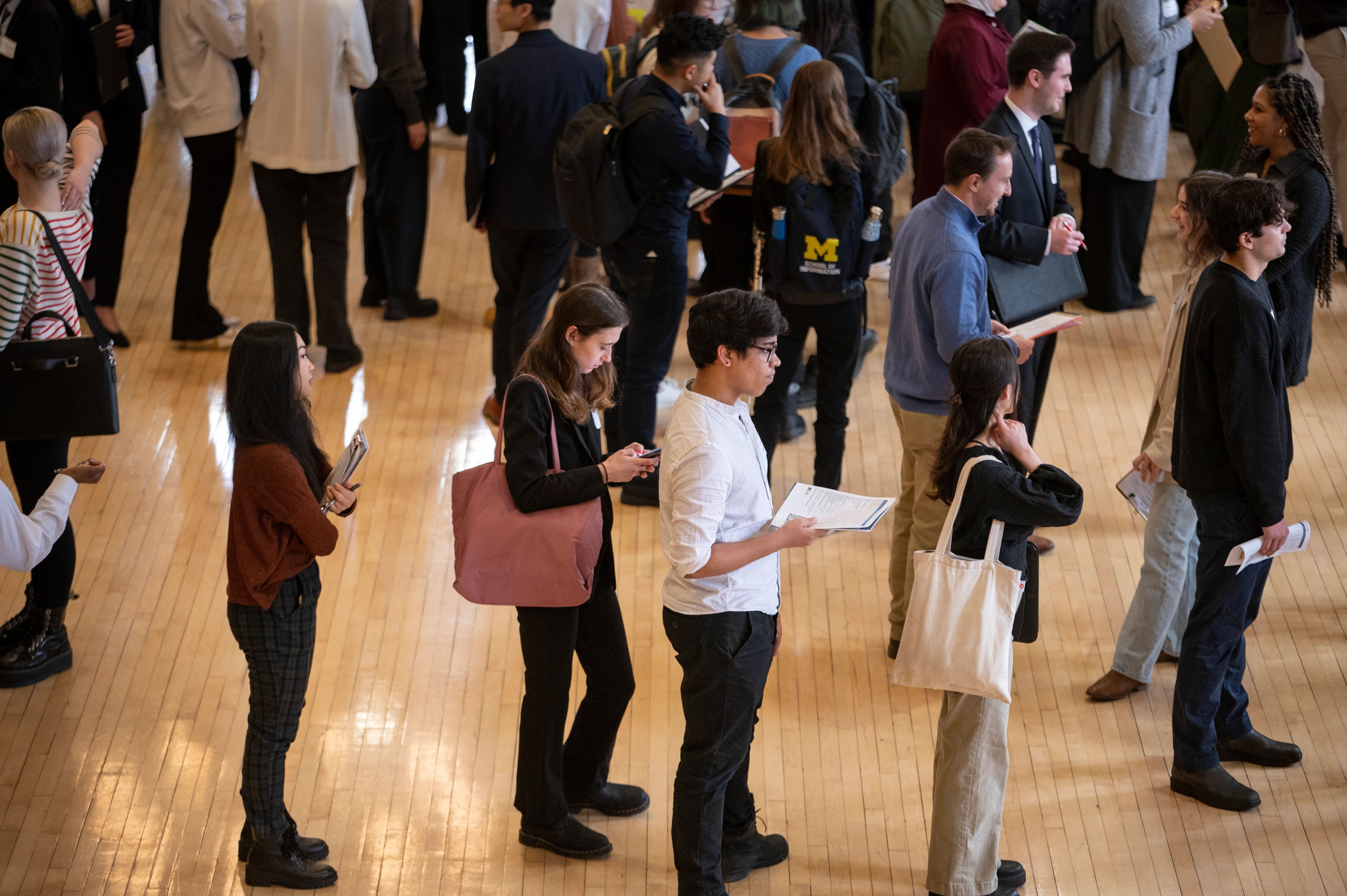 a lot of people carrying paper